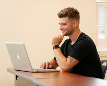 male student on a laptop